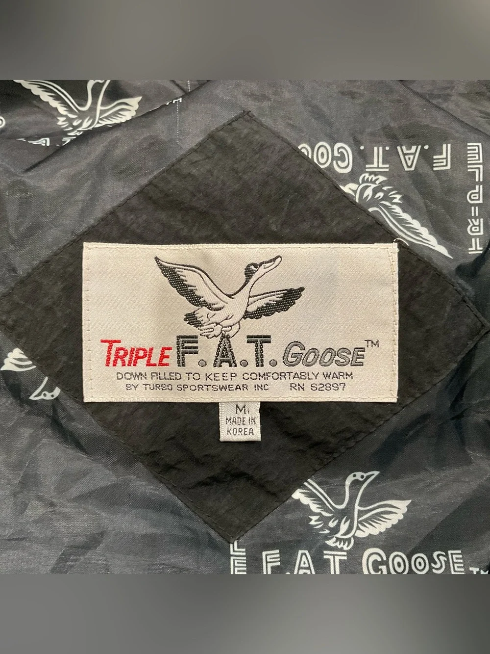 This vintage Triple F.A.T. Goose duck down ski parka features a striking.